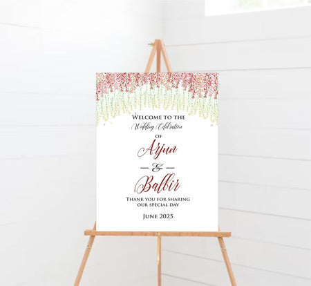 Floral wedding welcome sign with red, pink, and green hanging flowers on an A1 foam board