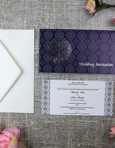 Close-up detail of ABC 671 letterpress wedding invitations, highlighting the intricate Arabesque design pattern in blue and silver, adding a touch of sophistication and artistry