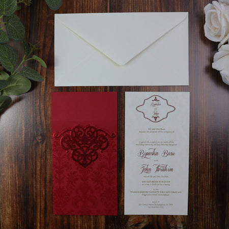 Flat lay view of laser cut invitation in Royal Red with gorgeous foiled accent