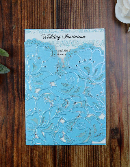 Flat-lay of the Sky Blue Laser Cut Pocket Invitation, showcasing the delicate laser-cut floral design and premium craftsmanship.