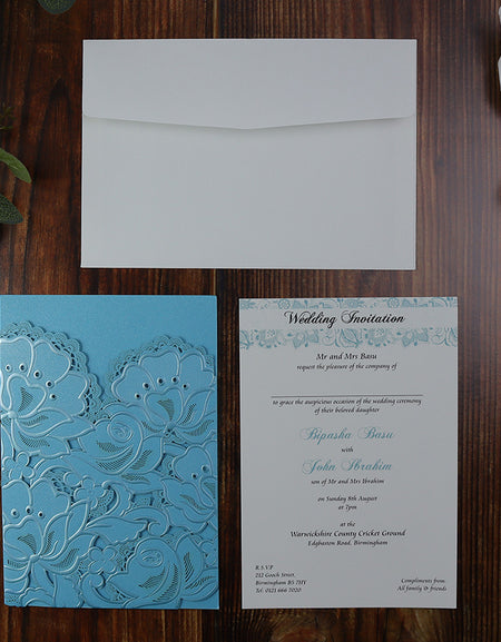 Open view of the Blue Laser Cut Wedding Invitation LC 1015, displaying the pocket-style insert section for additional wedding details.