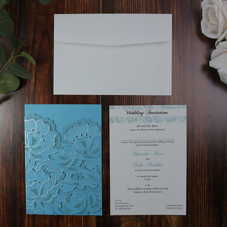 Open view of the Blue Laser Cut Wedding Invitation LC 1015, displaying the pocket-style insert section for additional wedding details.