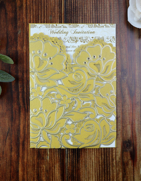 Close-up of the Shiny Gold Rose Laser Cut Pocket Wedding Invitation LC 1015, featuring embossed floral details and shimmering gold foil accents.