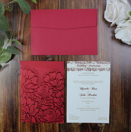 Flat-lay of the red laser-cut pocket invitation, showcasing the luxurious floral design and high-quality craftsmanship.