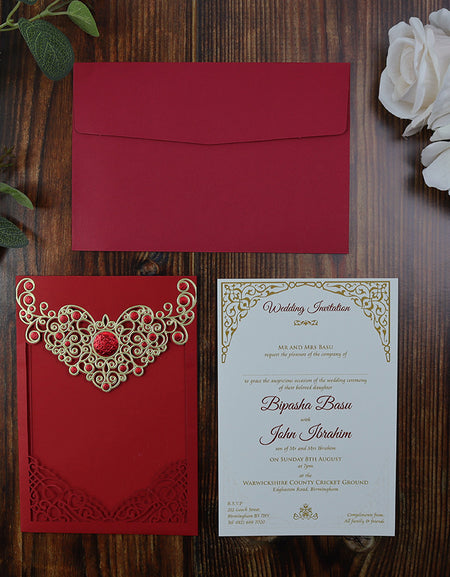 Flat-lay of the Red Laser Cut Wedding Invitation LC 6076, highlighting the intricate gold detailing and pocket insert design shadi card