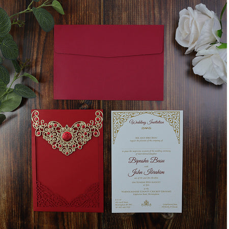 Flat-lay of the Red Laser Cut Wedding Invitation LC 6076, highlighting the intricate gold detailing and pocket insert design shadi card
