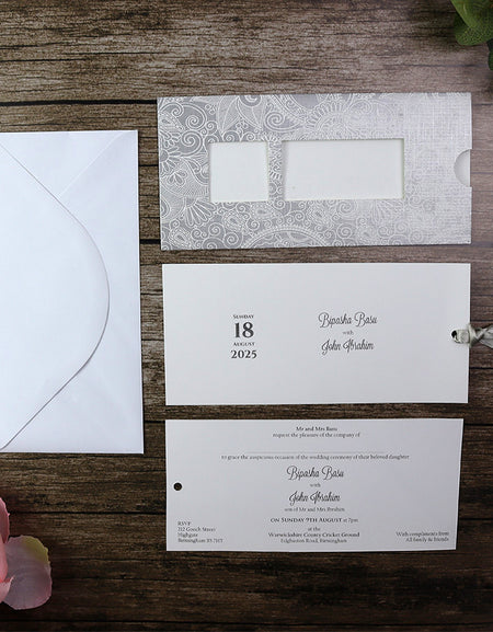 Close-up of the RWB Silver Wedding Invitation, highlighting the luxurious silver cardstock and detailed paisley design.