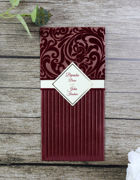 Maroon Velvet Pocket Invitation SC 2696 with diamond-shaped cut-out badge for customization from shaadicards