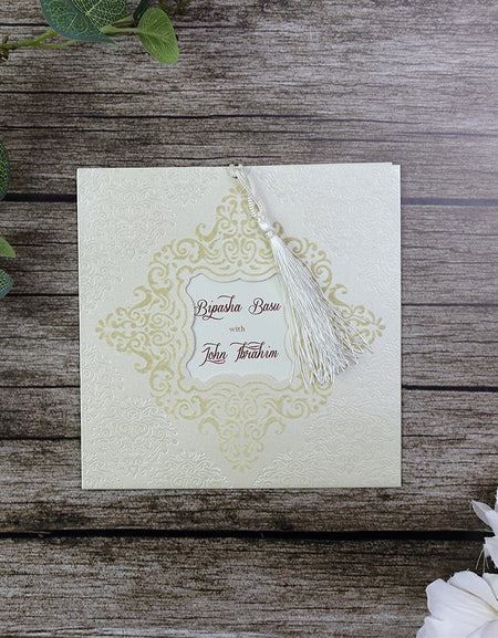 Close-up of Velvet Embossed Ivory Pocket Wedding Invitation SC 2789 with a decorative gold foil border and intricate cut-out window revealing custom text.