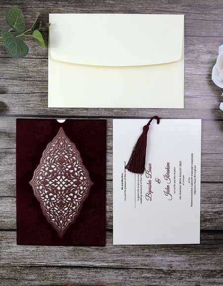 Close-up view of the Regal Red Velvet Wedding Invitation SC 5568 with intricate laser-cut details and personalized insert pulled from the side