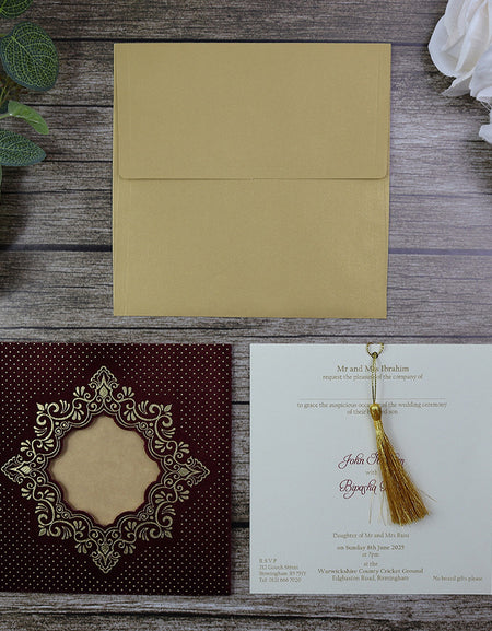 Close-up of Square Red Velvet Wedding Invitation SC 5596 with gold foil details and tassel, featuring an ornate cut-out window.