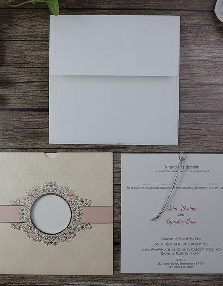 Open view of SC 5657 Invitation, revealing the pocket design with an insert visible through the circular cutout window, secured with a silver twine for a luxurious touch from Shaadi Card