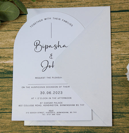 White wedding invite with black text and matching effervescent envelope