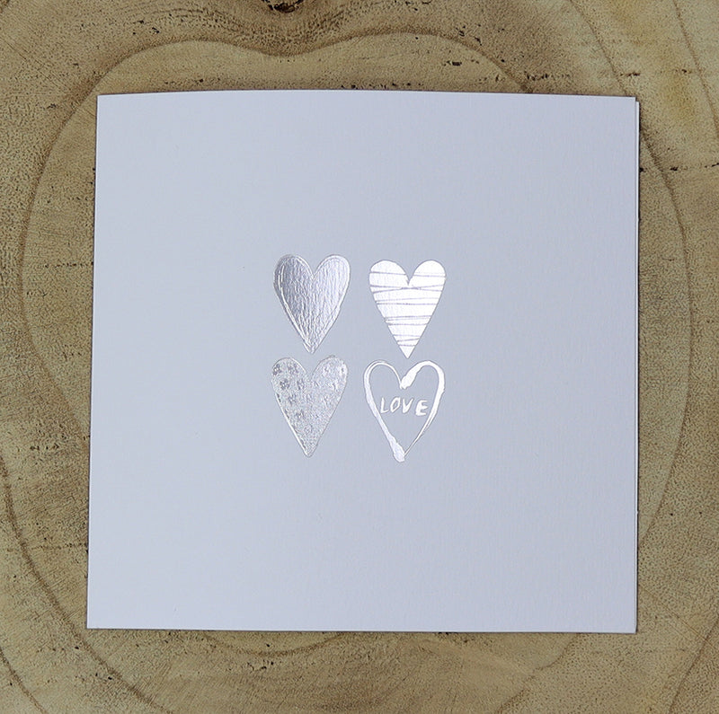 Open view of 5068 Invitation, highlighting the four uniquely filled silver hearts and minimalist design, perfect for budget-friendly weddings