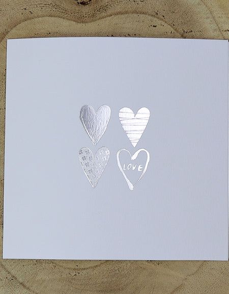 Open view of 5068 Invitation, highlighting the four uniquely filled silver hearts and minimalist design, perfect for budget-friendly weddings