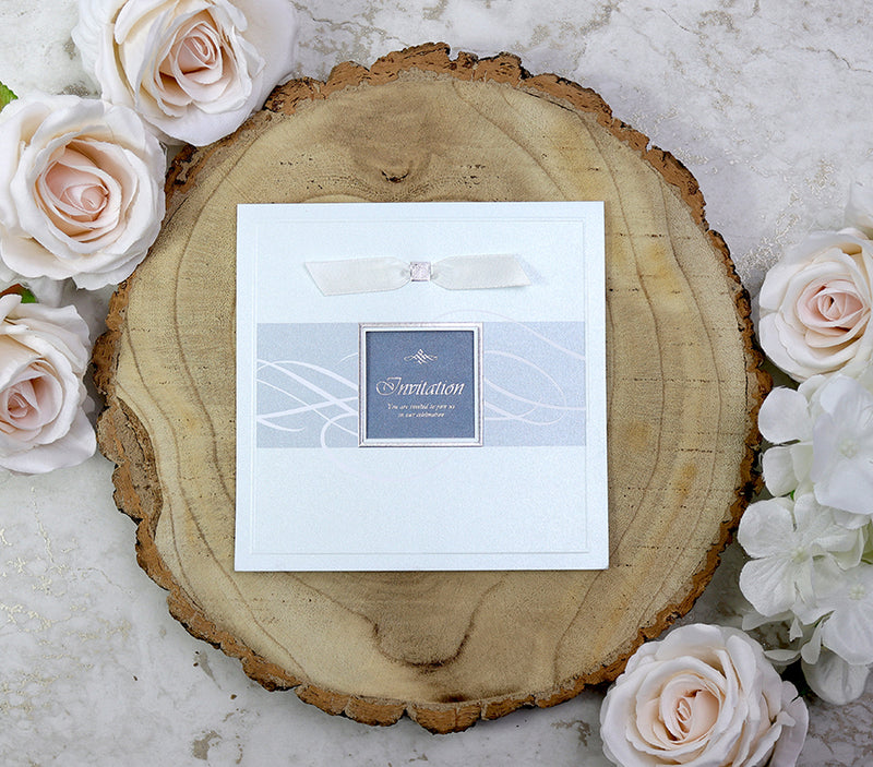 7006 Invitation with light shining through the square window cutout, highlighting the shimmering pearlescent cardstock and creating a beautiful, ethereal effect.