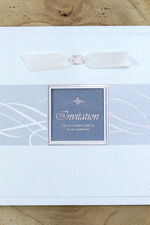 Load image into Gallery viewer, 7006 Light Blue Accent Silver Invitation displayed with its matching envelope, featuring shimmering pearlescent cardstock and a white ribbon for a cohesive and elegant stationery set
