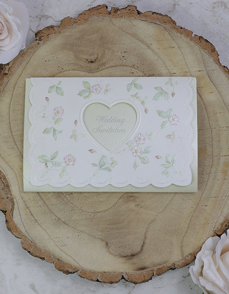 Front view of 7021 White & Light Green Invitation, showcasing a heart-shaped cutout and embossed green and pink floral patterns, creating a romantic and elegant design.