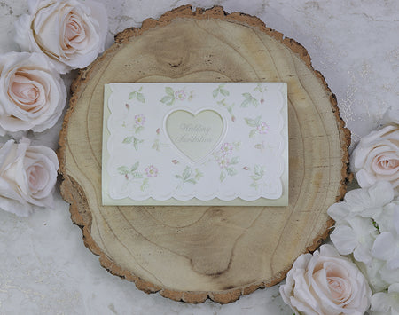 Front view of 7021 White & Light Green Invitation, showcasing a heart-shaped cutout and embossed green and pink floral patterns, creating a romantic and elegant design.