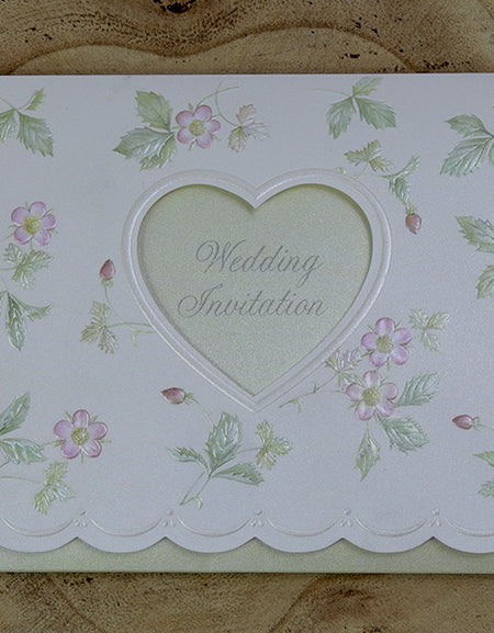 Open view of 7021 Invitation, revealing the heart-shaped cutout with text visible through the light green background and embossed floral patterns on the first fold