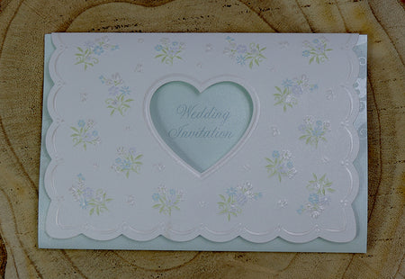 Open view of 7121 Invitation, revealing the heart-shaped cutout with light blue text reading 'Wedding Invitation' and the floral bouquet design on the first fold, perfect for weddings and formal events