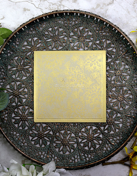 Close-up of 8556 wedding invitation highlighting the gold floral drawn pattern and embossed border.