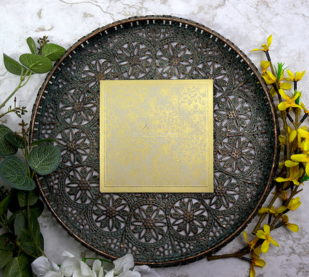 Close-up of 8556 wedding invitation highlighting the gold floral drawn pattern and embossed border.
