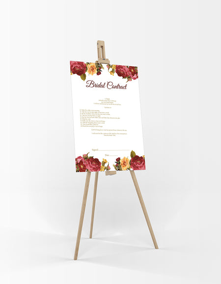 As seen resting on an easel a funny bridal contract between husband and wife with Deep red and yellow flowers