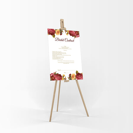 As seen resting on an easel a funny bridal contract between husband and wife with Deep red and yellow flowers