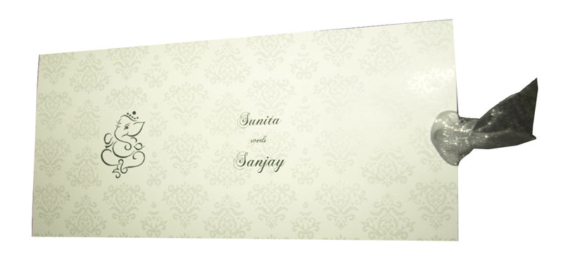 white wedding invitation with embossed floral design and Ganesh emblem cut-out