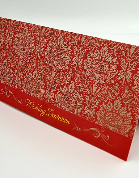 Front view of ABC 443 Traditional Damask Red Wedding Invitation, showcasing a red damask pattern with gold letterpressed 'Wedding Invitation' text at the bottom center