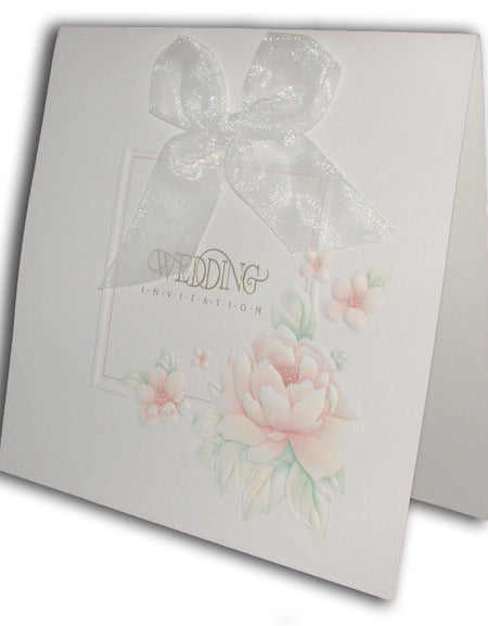 Close-up of BW16 ecru wedding invitation with gold foil text and red rose bouquet