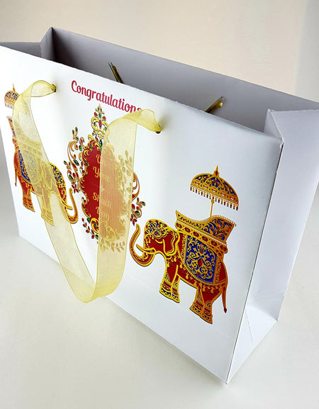 Side angle of the custom Indian wedding favor bag, showcasing intricate Mughal-style artwork and premium-quality finish from saddi cards