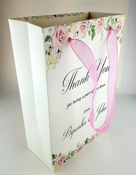 Close-up of Personalized Floral Gift Bag 102 featuring pink, ivory, and green floral design with a pink sheer ribbon handle
