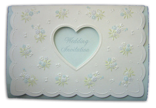 Load image into Gallery viewer, Close-up of 7121 Invitation, highlighting the shimmering white pearlescent cardstock and the intricate details of the floral bouquets and heart cutout, creating a luxurious and elegant look
