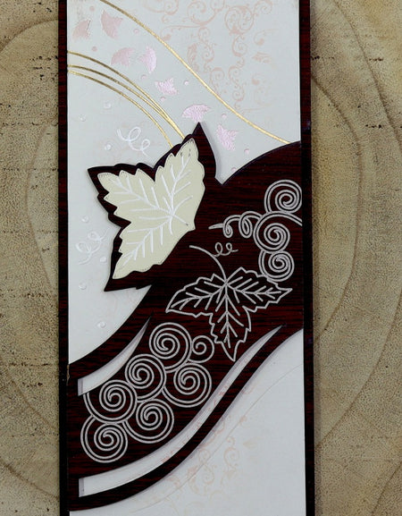 Close-up detail of WN075 Invitation, highlighting the handcrafted ivy leaf patterns carved into the brown wood, adding a touch of artistry and natural beauty from shadi card.com