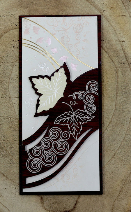 Close-up detail of WN075 Invitation, highlighting the handcrafted ivy leaf patterns carved into the brown wood, adding a touch of artistry and natural beauty from shadi card.com